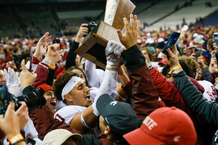 Washington State players lift the Apple Cup
